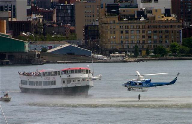 New York City Police helicopter hovers low over the Hudson River as it drops a police diver into the river